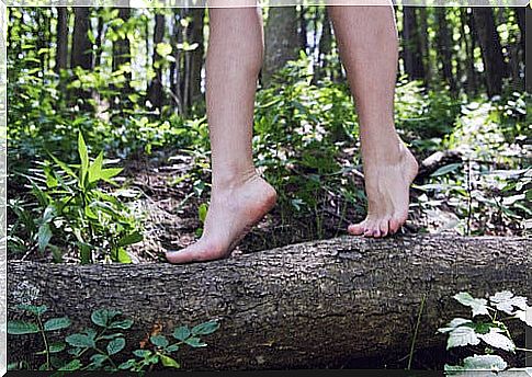 Woman walking down a log