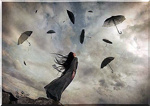 Woman looking at umbrellas flying in the sky