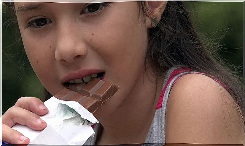 girl eating chocolate to improve concentration