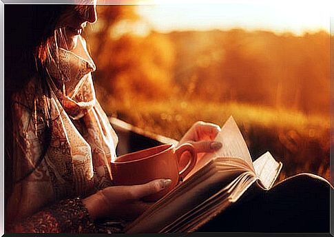 Woman having coffee and reading a book