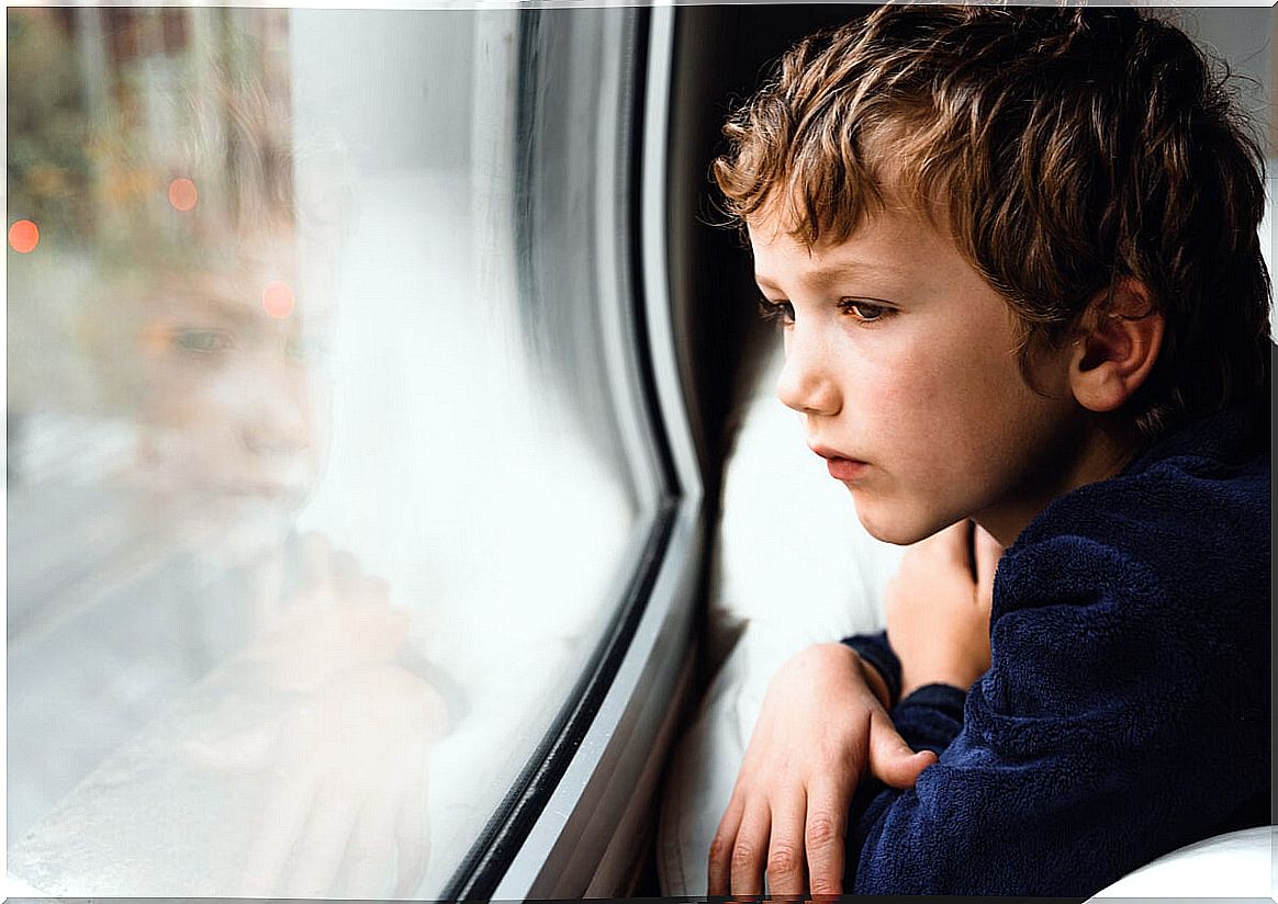 Sad child looking out the window