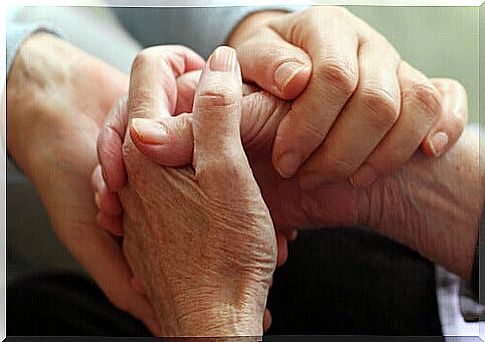 Holding the hands of a dying person symbolizing the art of doing good