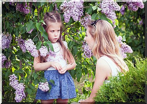 Mother explaining to her daughter consequences of bad behavior