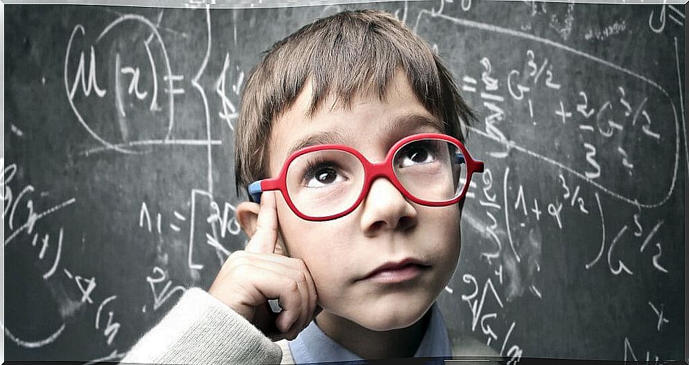 Boy with red glasses thinking