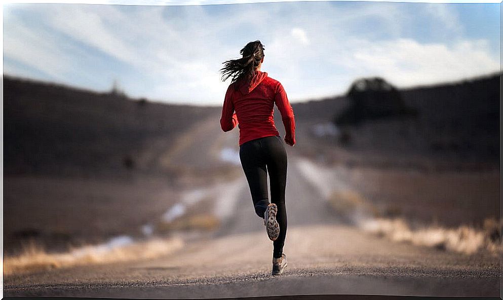 Woman running with red jacket