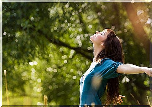 Woman with open hands enjoying nature