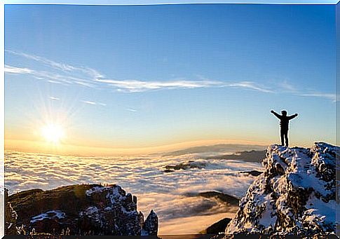 Man on top of the mountain to represent that motivating is giving reasons 