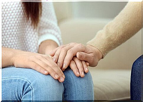 Hand of a psychologist on that of his patient to convey confidence and establish rapport