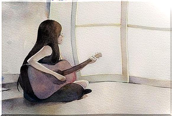 woman with guitar sitting on the floor