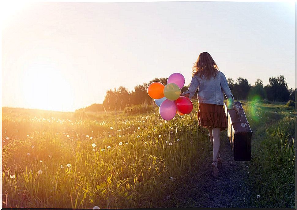 Woman with suitcase symbolizing an inner journey