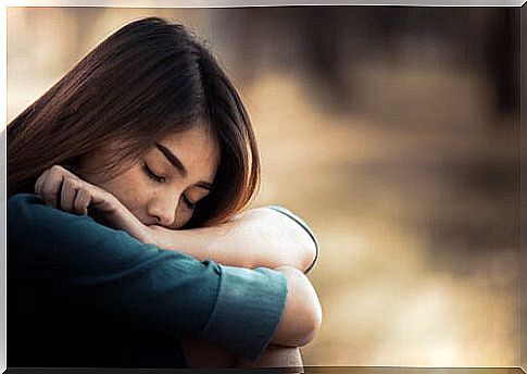 Woman with sadness leaning on her arms