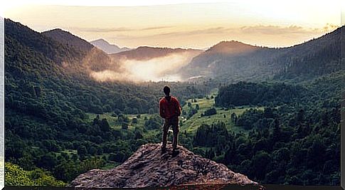 Man on mountain thinking about when you discover your strengths