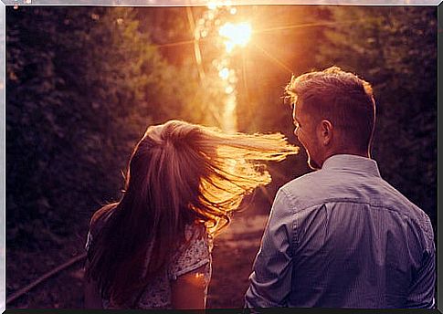 Lovers walking at sunset