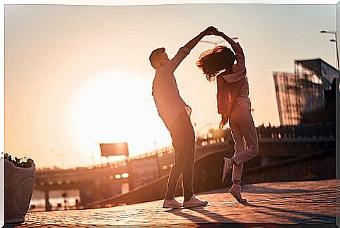 Lovers dancing at sunset 