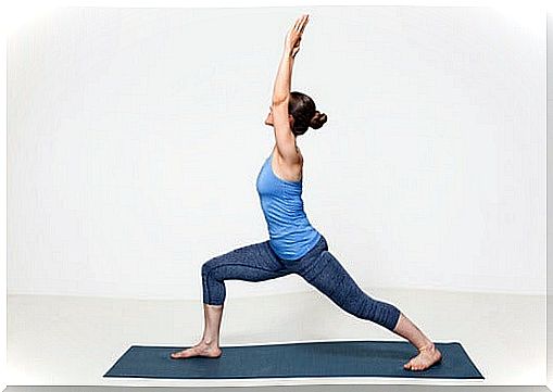 woman executing warrior pose in beginner yoga